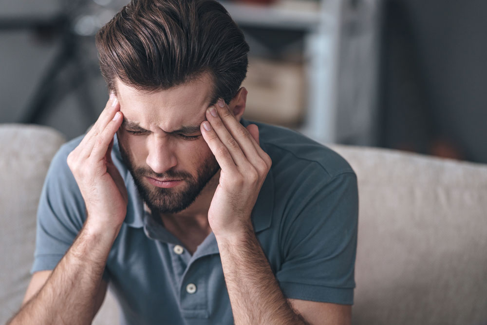 Man with a headache needs chiropractic care.
